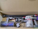 a box with a vacuum and other items inside of it