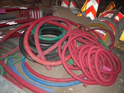 a pile of hoses and other construction equipment on the floor