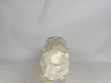 a small white elephant figurine on a white surface