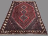 an oriental rug with a geometric design on a grey background