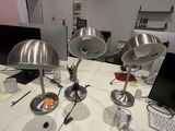 three lamps sitting on a white table in a room