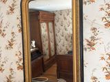 a mirror that is sitting on a dresser in a room