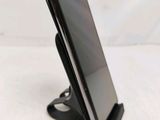 a cell phone that is sitting on a stand