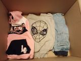 une boîte en carton contenant trois paires de vêtements