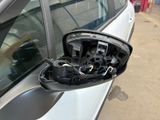 a side view mirror of a car on the side of the road