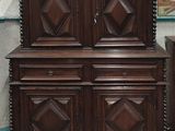 une armoire en bois derrière laquelle se trouve un tableau accroché au mur