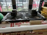 two air conditioners sitting on top of a box in front of a window