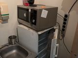 a small kitchen with a sink and a microwave in it