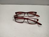 two pairs of glasses sitting on top of a box