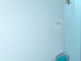 a bathroom with a toilet and a shower stall in it