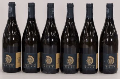 six bottles of wine are lined up in a row on a table