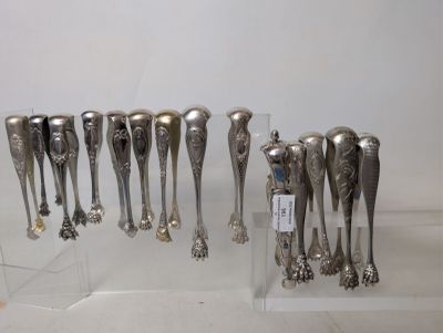 a lot of silver spoons on display in a display case