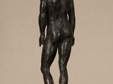 statue of a man standing on a table with his hands in his pockets