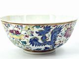a white bowl with blue and yellow designs on it