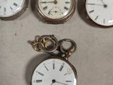 many different types of pocket watches sitting on a table