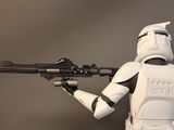 a star wars action figure that is holding a gun