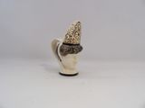 a small ceramic figurine of a man wearing a hat