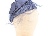 a mannequin headpiece with a bow on top of it