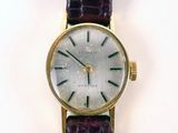 a close up of a wrist watch with a purple strap