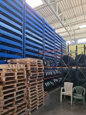a large warehouse filled with lots of pallets and chairs