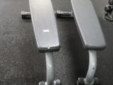 two benches in the middle of a gym room