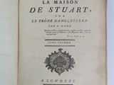 an open book with a picture of a coat of arms on top of it