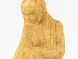 an old statue of a woman holding a baby in her arms