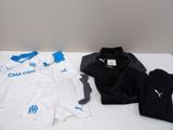 several soccer shirts are lined up on a white table