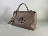 a brown leather handbag on a white background