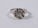 a close up of a diamond ring on a white surface
