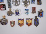 a lot of badges that are on a white surface