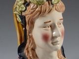 a ceramic figurine of a woman with a crown on her head