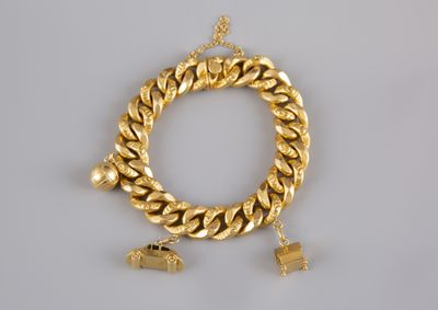 a gold chain bracelet with charms on a white background