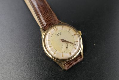a close up of a wrist watch on a table