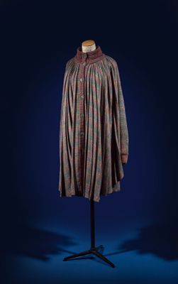 a dress on a mannequin stand against a blue background