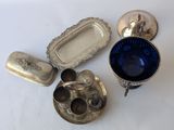 several silver objects are sitting on a white surface