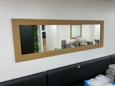 a picture of a dining room with a large mirror on the wall