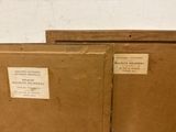 two brown boxes with labels on them sitting on a table