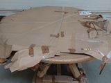 a table made out of cardboard sitting in a garage
