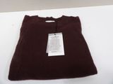 the shirt is brown and has a tag on it