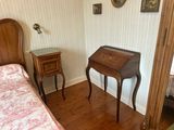 a bedroom with a bed and a desk in it