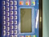 a small blue electronic device with a keyboard on top of it