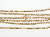 a close up of a gold chain on a white background