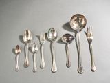 a lot of silver spoons and spoons on the table