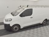 a white van parked in a room with a checkered floor