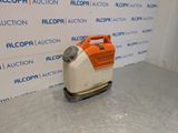 an orange and white machine sitting on top of a cement floor