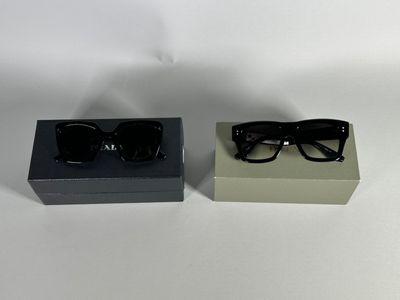 pair of black sunglasses in a black box on a white surface