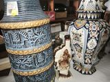 three vases sitting on a table in a room