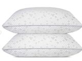 a pair of pillows sitting on top of each other on a white surface