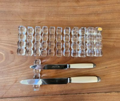 three knives and a glass holder on the table
